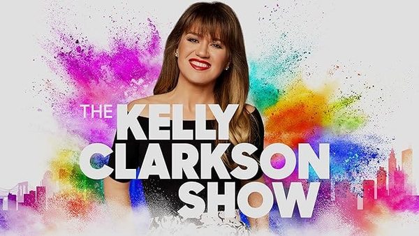 Smiling woman with long hair against colourful paint-powder splashes, with the words The Kelly Clarkson Show.