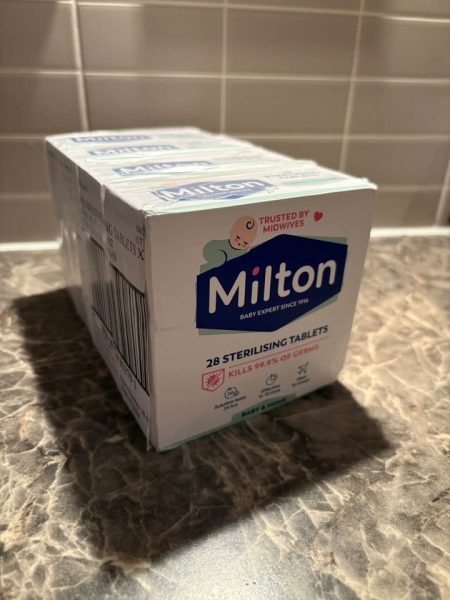 A multipack of Milton sterilising tablets, 28 per box, on a kitchen worktop.